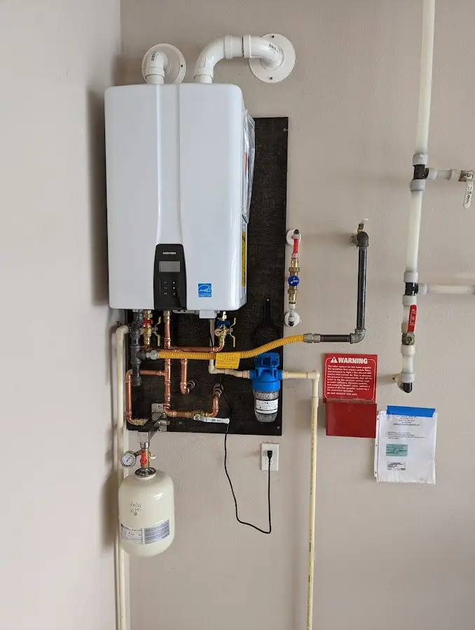 Professional plumber installing copper piping in a Grayslake home